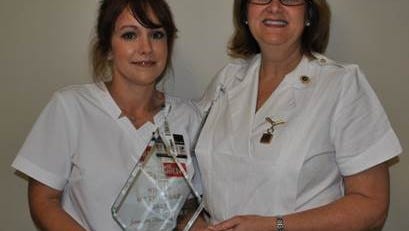Chief Nursing Officer Phebe McKay (right) recognizes Jennifer Thornhill as Merit Health Wesley’s Nurse of the Year.