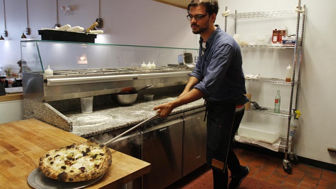 Steve Mignogna of Ocean Grove, co-owner of Talula’s, prepares the Spring Spud sourdough pizza, made with new potatoes, bacon fat basamella, garlic, Benton’s bacon, aged provolone and fresh herbs, inside his Cookman Avenue restaurant in Asbury Park.