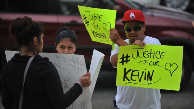 Family and friends of murder victim Kevin Carrillo hold signs outside Cumberland County Courthouse Tuesday, Sep. 27, 2016 in Bridgeton.  