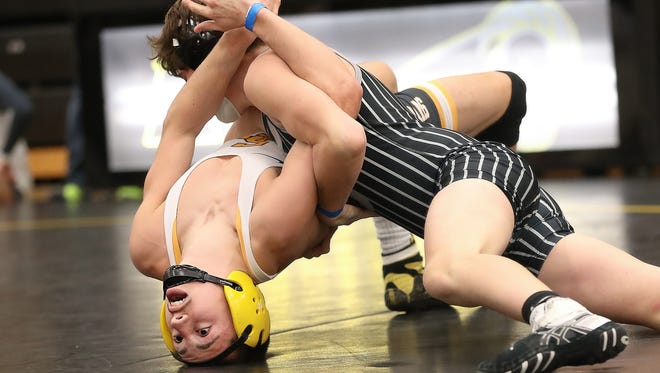 Ankeny Centennial's Noah Blubaugh tries to pin Southeast Polk's Mark Ames during the CIML conference tournament at Southeast Polk High School.