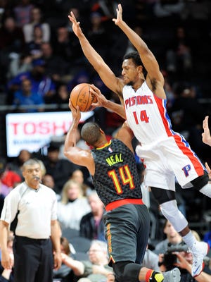Pistons' Ish Smith fouls the Hawks' Gary Neal in the fourth quarter.