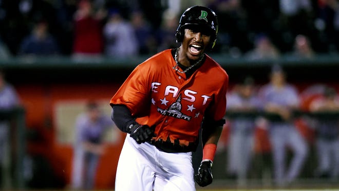 Eastern's Montrell Marshall celebrates winning run in the tenth inning during the Midwest League All-Star game on Tuesday, June 19, 2018, at Cooley Law School Stadium in Lansing.