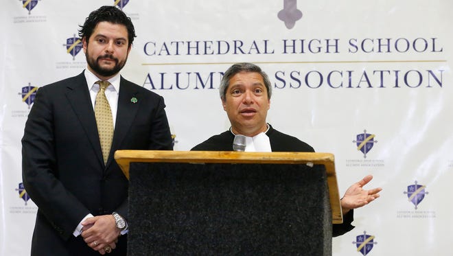 David Saucedo, left, president of the Council of Presidents at Cathedral High School, and Brother Nick Gonzalez, president of the school, on Thursday announce that the keynote speaker for the school’s 90th anniversary gala Oct. 20 at the El Paso convention center will be former Notre Dame football head coach Lou Holtz.