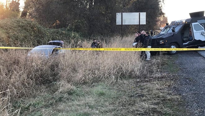 A car authorities believed was stolen sits in a ditch off Interstate 5 near Knighton Road on Thursday, Dec. 6, 2018. Authorities said the man who was driving the car was shot and killed by officers.