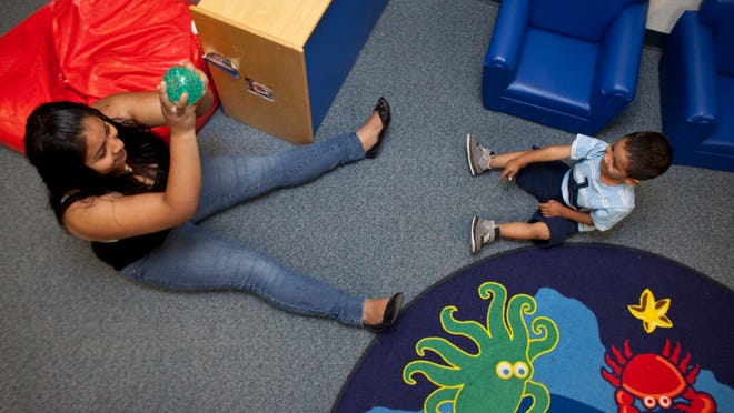 
Jazmin Salgado (left) and her son, Brayhen Rios, play catch at the Compadre High School daycare. Jazmin is among the teen girls who have beat the odds and completed high school after becoming pregnant. 
