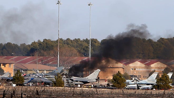 Smoke rises from a military base after a plane crash in Albacete, Spain, Monday, Jan. 26, 2015.