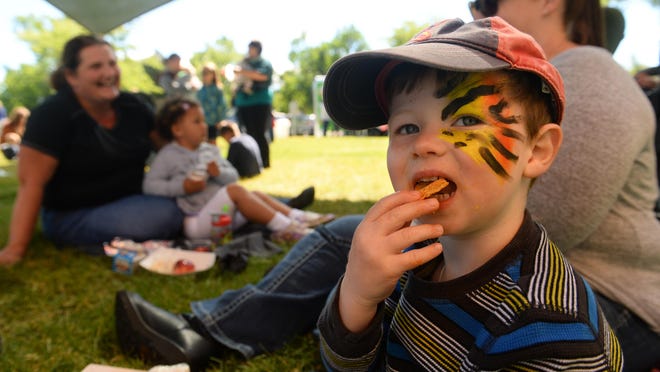 Noah Kauffman, age 3, eats lunch at the Great Falls Public Schools Nutrition Program's summer meals program at Gibson Park on Thursday morning.
