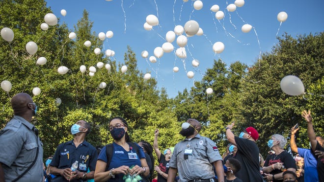 People release their balloons outside the Augusta University Medical Center Thursday morning August 20, 2020, in remembrance nurse Yolanda Coar who died recently of COVID-19.