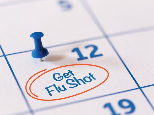 The words Get vaccinated against the flu written on a calendar