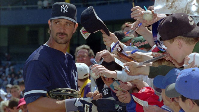 New York Yankees first baseman Don Mattingly obliges fans with autographs before the home opener against the Texas Rangers, at New York's Yankee Stadium, April 26, 1995.