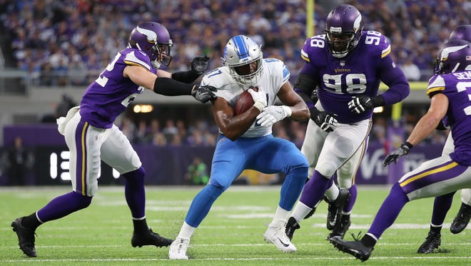 Oct 1, 2017; Minneapolis, MN, USA; Vikings safety Harrison Smith (22) and defensive tackle Linval Joseph (98) tackle Lions tight end Darren Fells in the first half at U.S. Bank Stadium.
