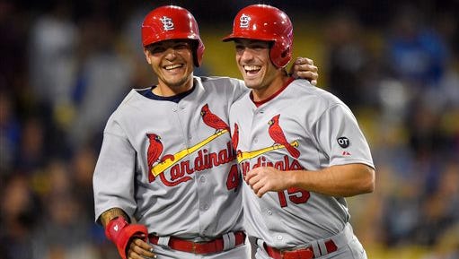 St. Louis Cardinals' Yadier Molina, left, and Randal Grichuk celebrate after scoring on a double by Kolten Wong during the eighth inning of a baseball game against the Los Angeles Dodgers, Thursday, June 4, 2015, in Los Angeles. (AP Photo/Mark J. Terrill) 
