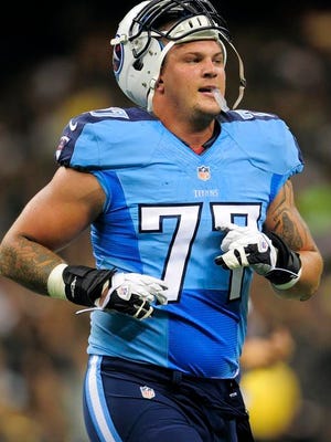 Titans tackle Taylor Lewan makes his way to the sideline during the first half against the Saints on Friday.