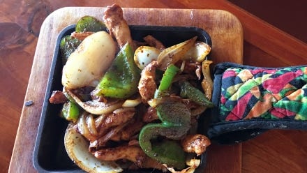 Cinco de Mayo's chicken fajitas were served in the square cast iron mini skillet with a chili pepper mitt covering the hot handle.