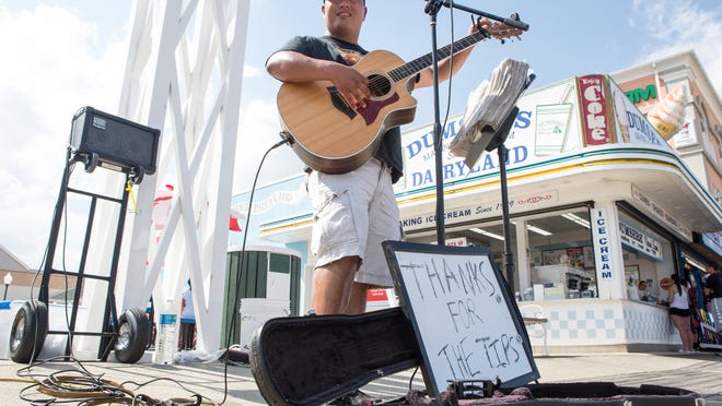Alex W. Young of North Carolina performs along the Boardwalk at the end of Caroline Street in Ocean City. He has been performing country and classic rock covers in Ocean City since 2012.