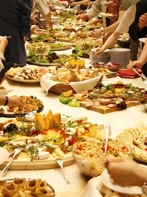 Hosting a potluck party for family and friends lets you divide the work among everyone.