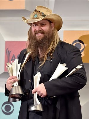 Chris Stapleton poses in the press room with the awards for album of the year for "Traveller", new male vocalist of the year, male vocalist of the year and song of the year for Nobody to Blame, at the 51st annual Academy of Country Music Awards at the MGM Grand Garden Arena on Sunday, April 3, 2016, in Las Vegas. (Photo by Jordan Strauss/Invision/AP)