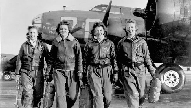 Four female pilots leaving their ship at the four engine school at Lockbourne are members of a group of WASPS who have been trained to ferry the B-17 Flying Fortresses during World War II