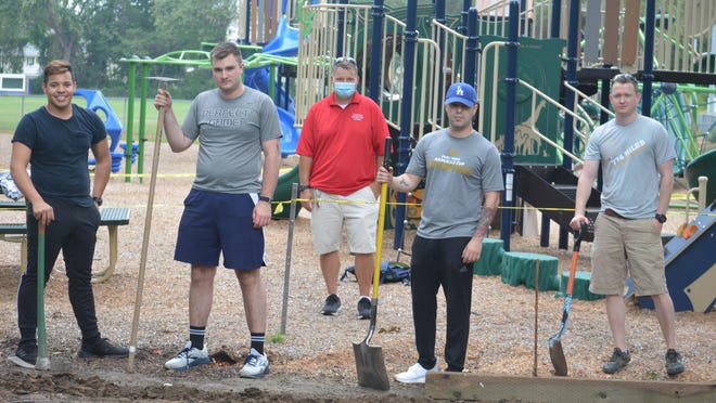 From left, USS Virginia crew members Manuel Benabe, Jake Rogan, Silberio Quintero and Ross Wilson volunteer with some landscaping at Kids Kingdom in Hampton Thursday morning. Hampton Parks and Recreation Director Rene Boudreau is in back.