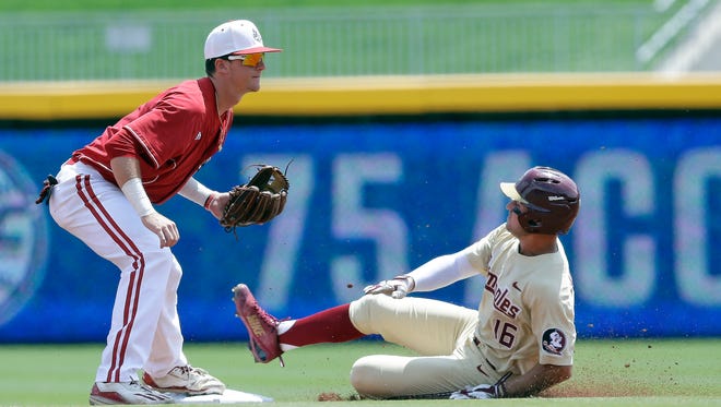 Florida State's Mike Salvatore (16) is forced out at second base as Louisville infielder Tyler Fitzgerald tags the base during the first inning of an Atlantic Coast Conference NCAA college baseball tournament championship game in Durham, N.C., Sunday,.