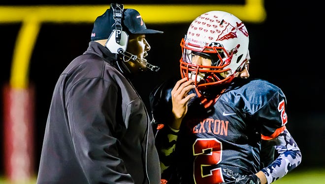 Sexton coach Dan Boggan, shown talking with quarterback Jackson Barnes during a recent game, became the school's career wins leader last week.