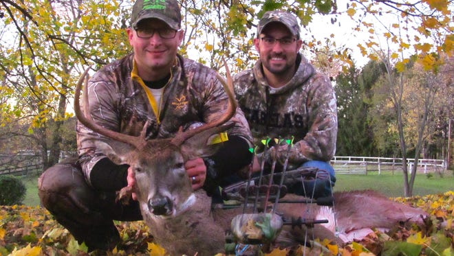 In his second season as a Pennsylvania bowhunter, Sgt. Zachary Teisher, left, took this nice buck on the author's small acreage property.
