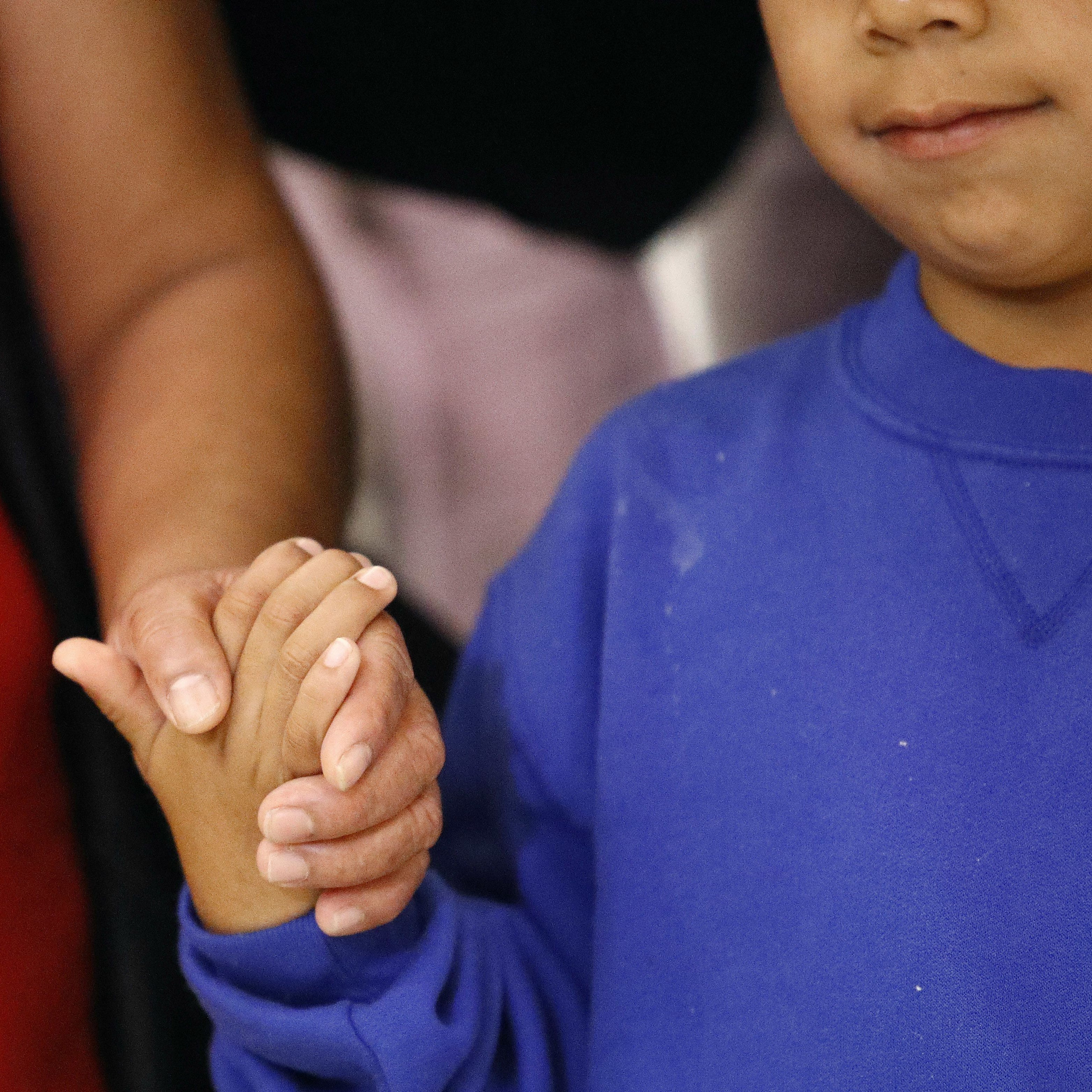 A mother and son from Guatemala hold hands during a news conference June 22, 2018, following their reunion in Linthicum, Md., after being separated at the U.S. border.