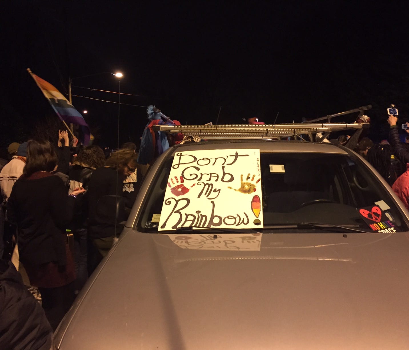 Participants dances and march in the Chevy Chase, Md., neighborhood. On the windshield sits a sign that reads 