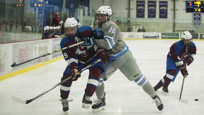 South Burlington’s Jared Baron, right, checks Spaulding's Collin McFaun into the boards during the boys hockey game between Spaulding and South Burlington at Cairns Arena on Wednesday.