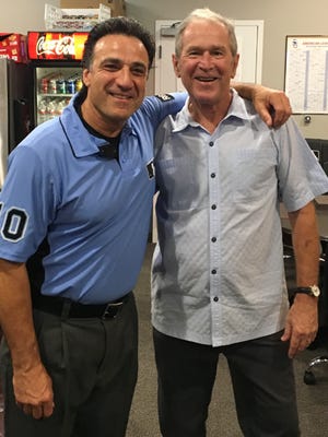 Belleville native Phil Cuzzi with former President George W. Bush earlier this season. Cuzzi will be the home plate umpire in Game 1 of the World Series on Oct. 24.