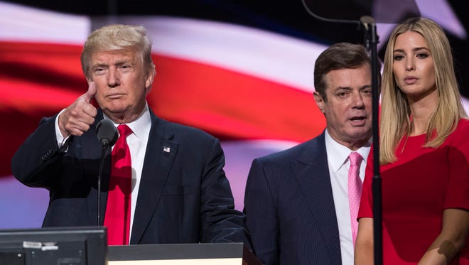 Manafort stands between Donald Trump and Ivanka Trump during a walkthrough at the Republican National Convention in Cleveland on July 21, 2016.