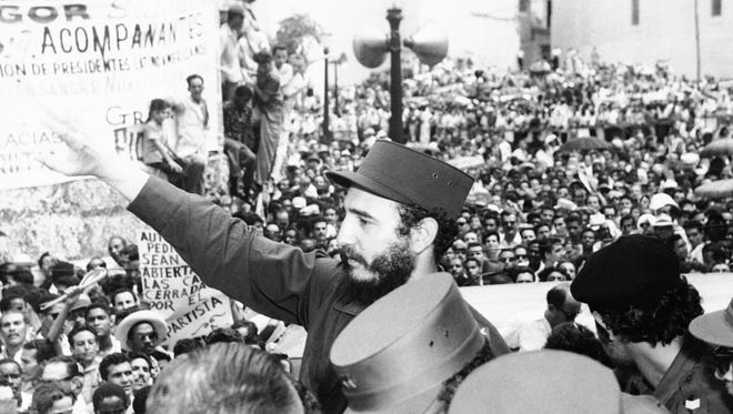 Fidel Castro, Cuba's prime minister, salutes the crowd at labor rally supporting him in Havana on March 22, 1959.