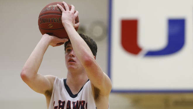 Urbandale's Brody Egger (23) extends the J-Hawks overtime lead with a pair of free throws against Valley Friday, Feb. 6, 2015, at Urbandale High School.