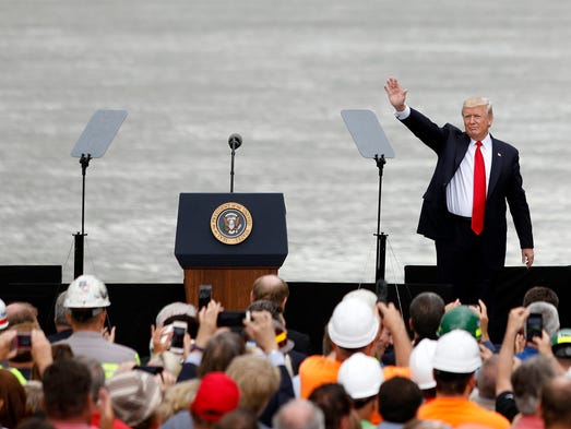 Trump waves to the crowd after delivering a speech