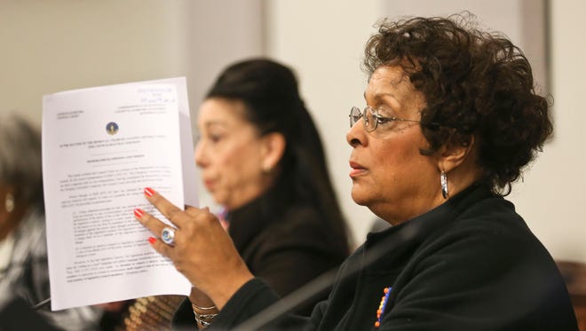 Metro Councilwoman Cheri Bryant Hamilton, pictured right, reads through a document.