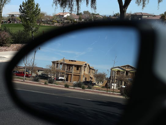 New homes are under construction at a housing development