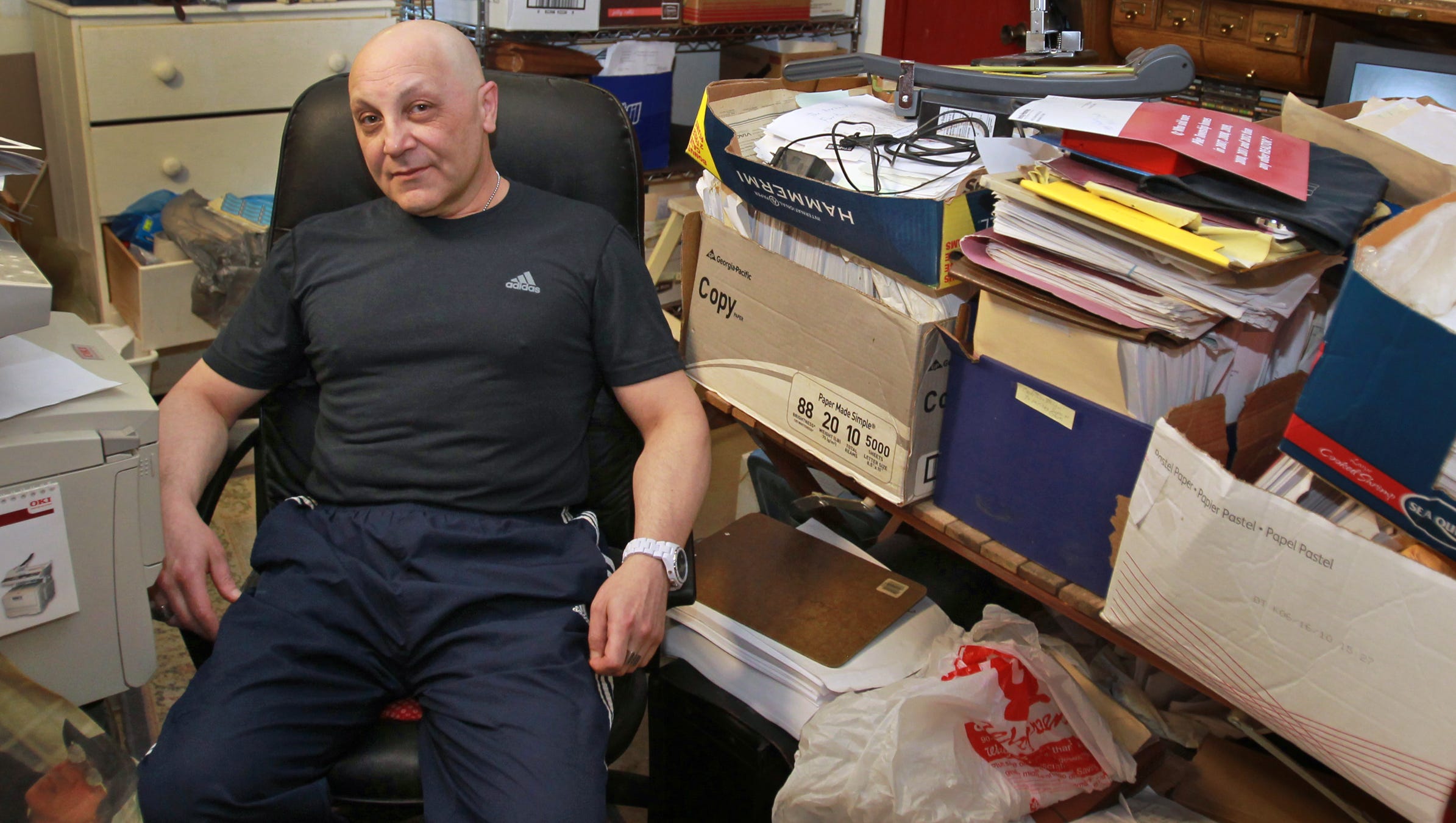 Gersh Zavodnik poses in a room in his home, Tuesday, May 14, 2013, that is full of files for the vast number of lawsuits he has filed.