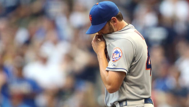 Mets starting pitcher Jonathon Niese reacts after giving up three runs to the Milwaukee Brewers in the fifth inning at Miller Park on Saturday.