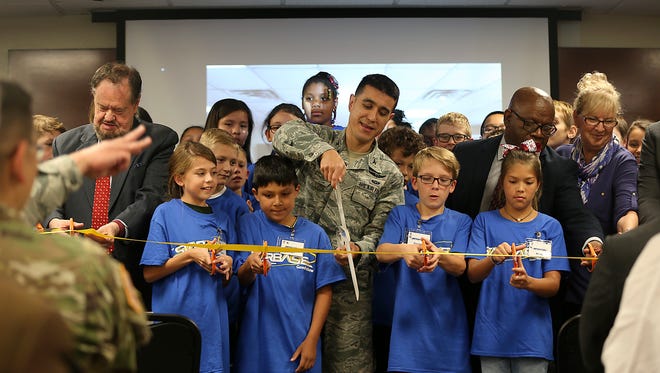 Col. Ricky Mills, 17th Training Wing commander at Goodfellow Air Force Base, along with fifth graders from Santa Rita Elementary and community representatives cut the ribbon dedicating a building on base for the newly implemented STARBASE program Oct. 4. 2017.