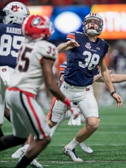 Auburn place kicker Daniel Carlson (38) reacts as his