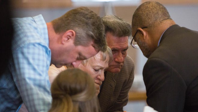 Assistant District Attorney Gerald Byers, right, speaks with the family of Jeremy Martin on Friday, May 12, 2017, during the fifth day of the retrial of Tai Chan. Chan shot and killed Martin in October 2014 while the Santa Fe County sheriff's deputies were staying at Hotel Encanto in Las Cruces. Chan, who claims self-defense, is on trial for murder.