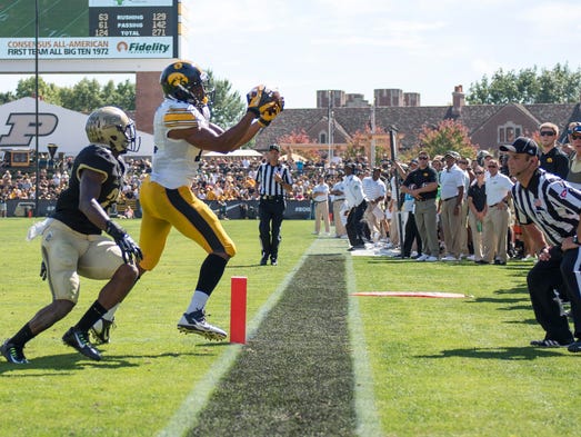 Sep 27, 2014; West Lafayette, IN, USA; Iowa Hawkeyes wide receiver Kevonte Martin-Manley (11) catches a ball against Purdue Boilermakers cornerback Antoine Lewis (23) which required being reviewed by the referred and was eventually awarded as a touchdown during the second half of the game at Ross Ade Stadium. Mandatory Credit: Marc Lebryk-USA TODAY Sports