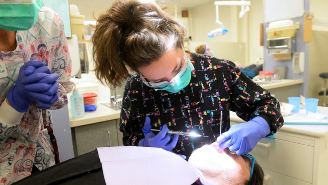 Dental hygienist student Kristyn Lund practices palatal injections on classmate Daniel Seymour. Dental students at Great Falls College MSU will provide free services Saturday at the No Smile Left Behind Community Dental Day.