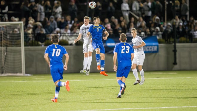 Guillermo Delgado goes up for a header against Providence.