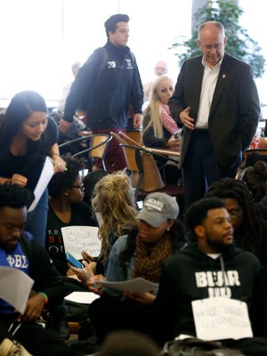 Missouri State University President Clif Smart talks with a demonstrator in the Plaster Student Union on Thursday, Nov. 12, 2015 during a sit-in to show support for #WeStandWithMizzou.