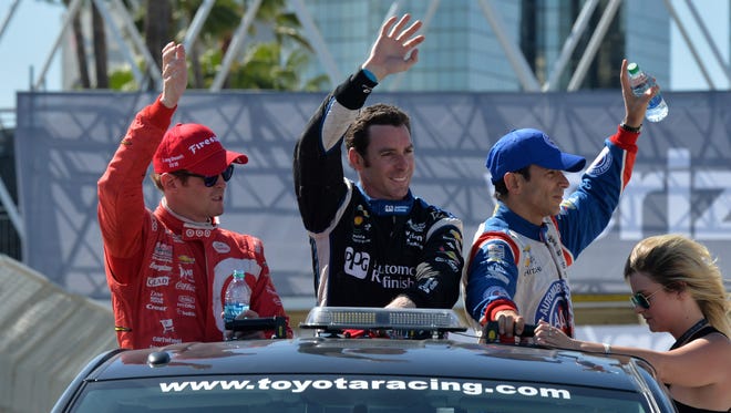 Toyota Grand Prix of Long Beach winner Simon Pagenaud, center, takes a victory lap with runner-up Scott Dixon, left, and third-place finisher Hello Castroneves on the streets of Long Beach. Mandatory