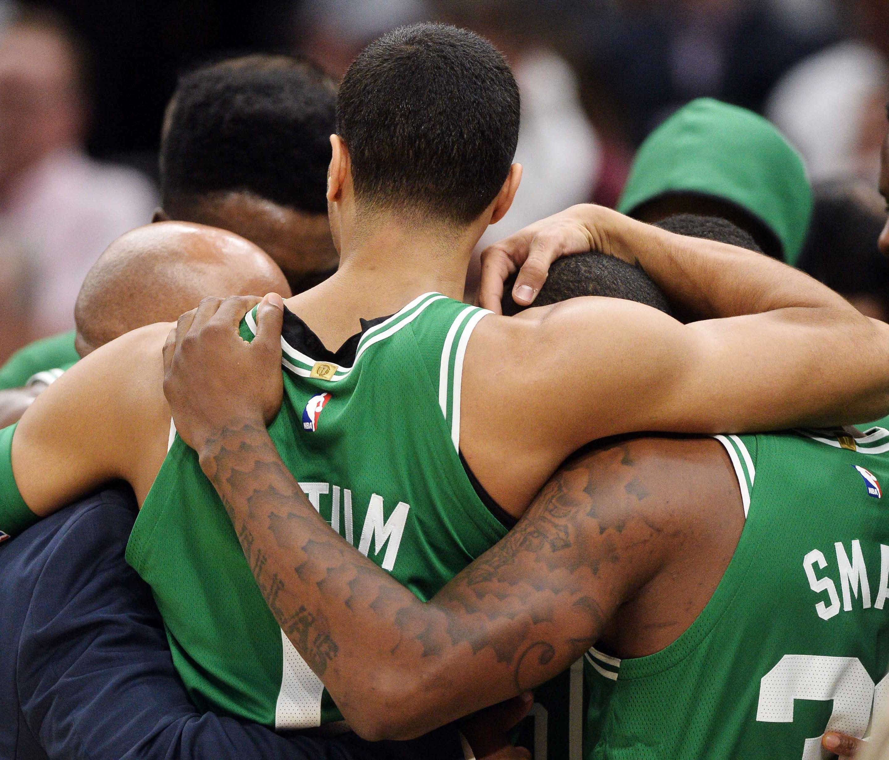 Celtics players hold each other after Gordon Hayward's injury.