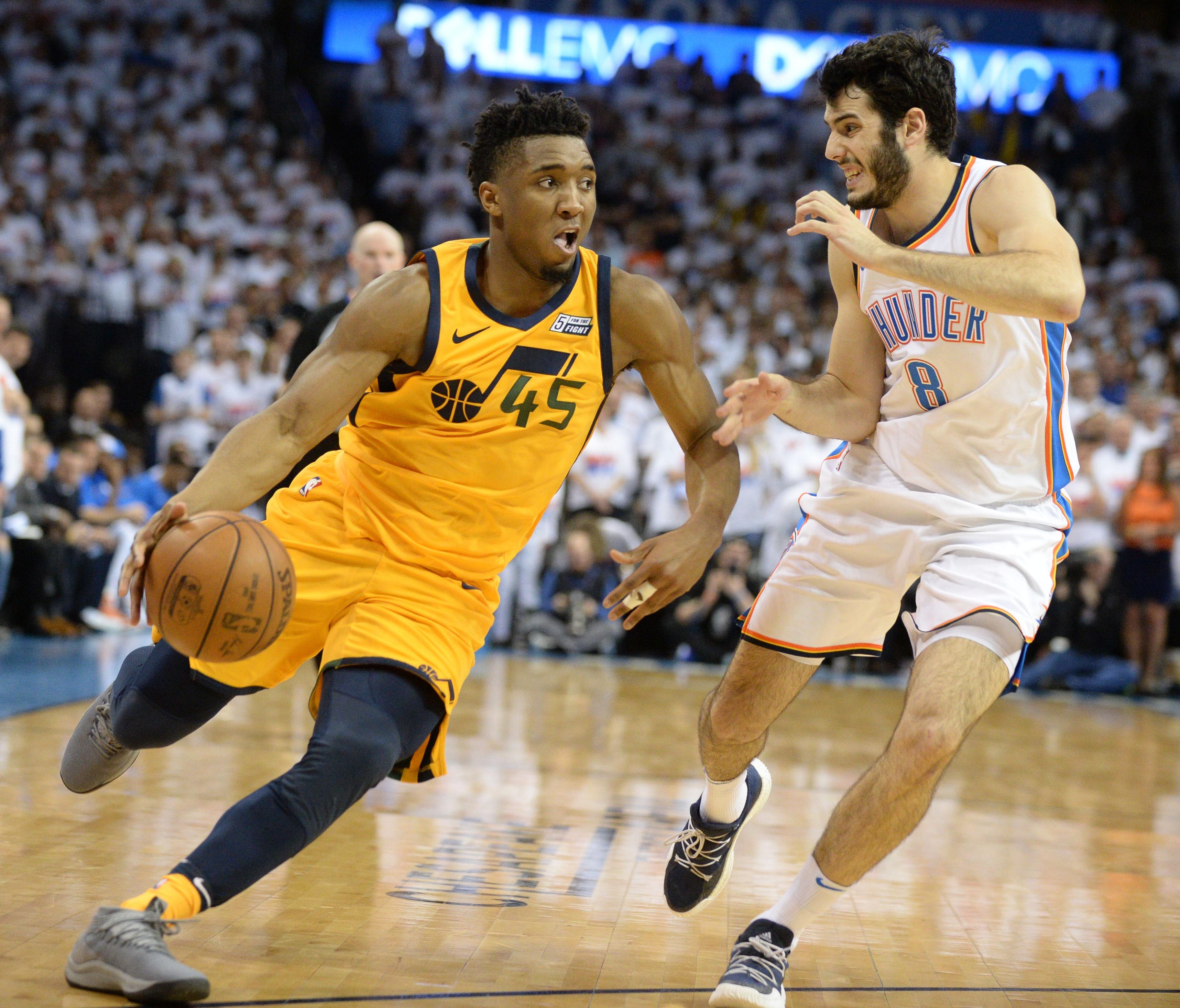 Utah Jazz guard Donovan Mitchell (45) dribbles the ball as Oklahoma City Thunder guard Alex Abrines (8) defends during the fourth quarter in game two of the first round of the 2018 NBA Playoffs at Chesapeake Energy Arena.