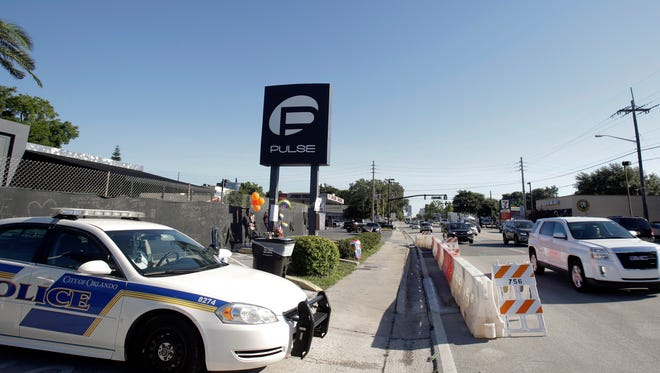 FILE - In this June 22, 2016, file photo, traffic moves along Orange Avenue after authorities opened the streets around the Pulse nightclub, scene of a mass shooting in Orlando, Fla. (AP Photo/John Raoux, File)