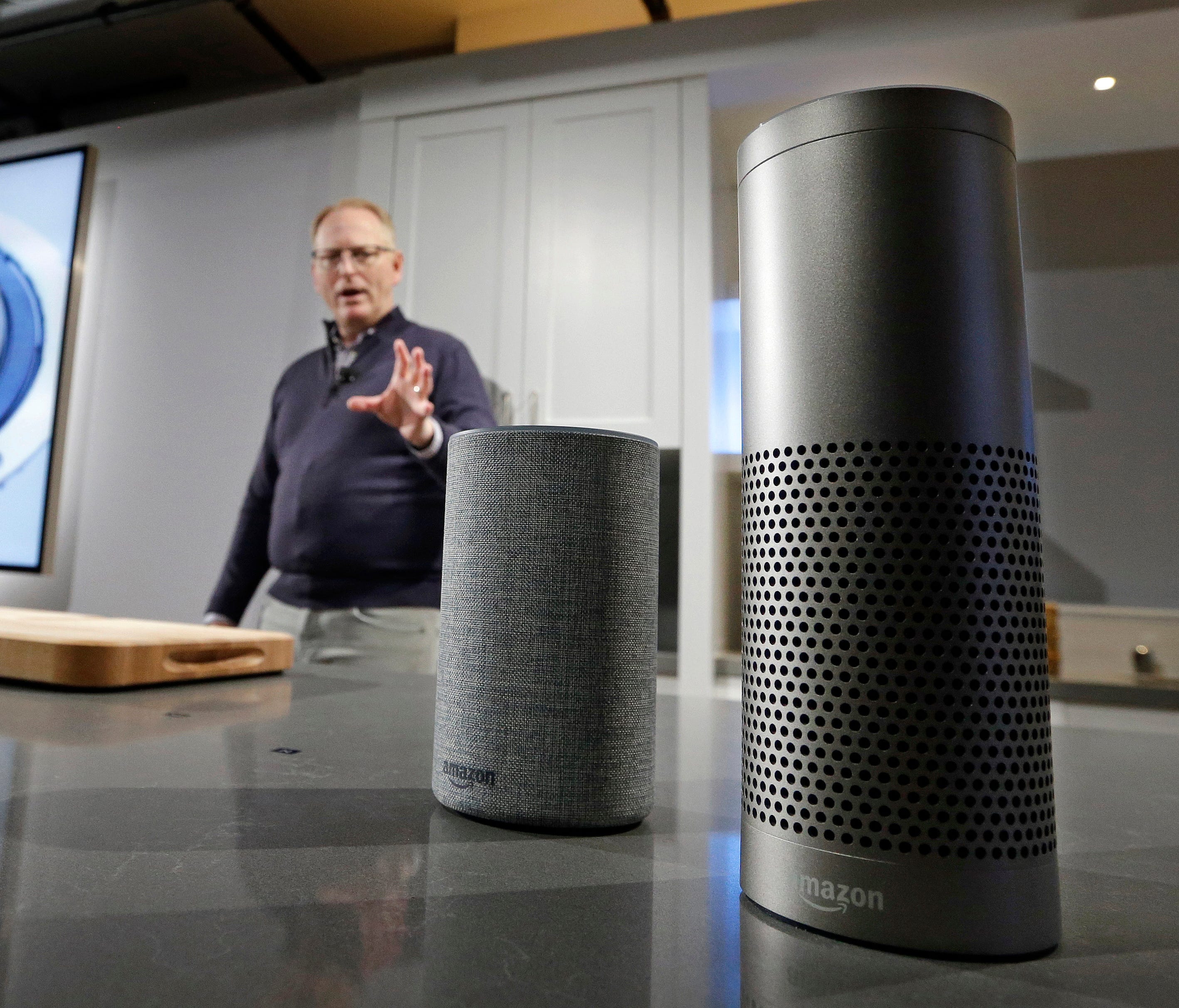David Limp, senior vice president of Devices and Services at Amazon, displays a new Echo, left, and an Echo Plus on Sept. 27, 2017, in Seattle.